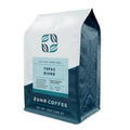A 12 oz bag of Zuna Coffee Topaz Blend medium roast coffee, featuring a white and dark teal packaging design with a light blue label.