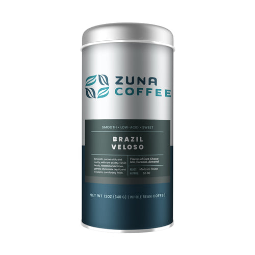 A silver cylindrical canister of Zuna Coffee Brazil Veloso whole bean coffee, featuring a dark teal label with white text, set against a plain white background.