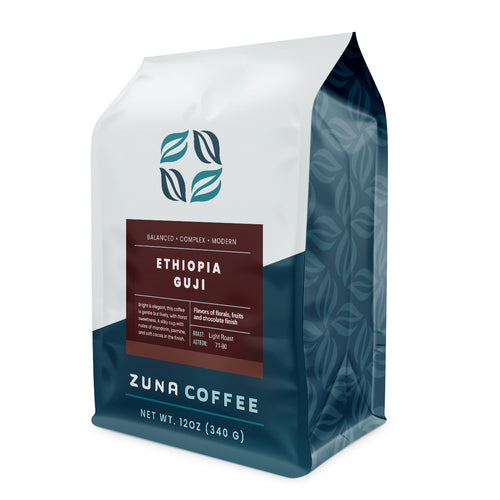 A 12 oz bag of Zuna Coffee Ethiopia Guji light roast coffee, featuring a white and dark teal bag with a dark brown label.