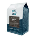 A 12 oz bag of Zuna Coffee Sumatra Garuda dark roast whole bean coffee, featuring a white and dark teal bag with a dark brown label.